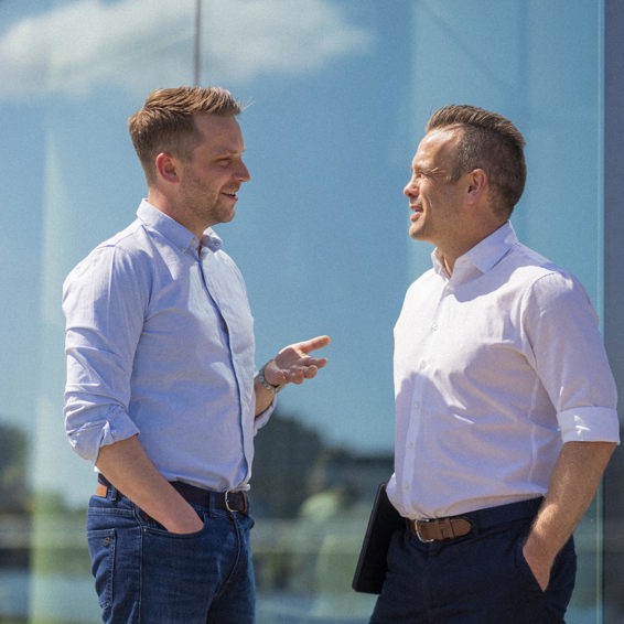Two colleagues engaging in conversation outside in Copenhagen