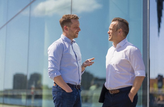 Two colleagues engaging in conversation outside in Copenhagen