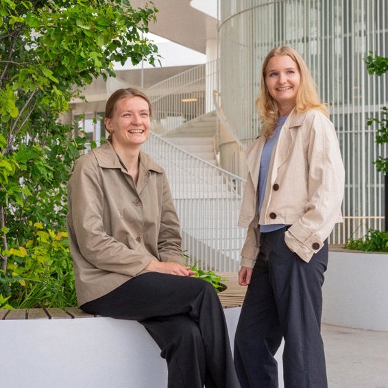 Two women laughing at the camera