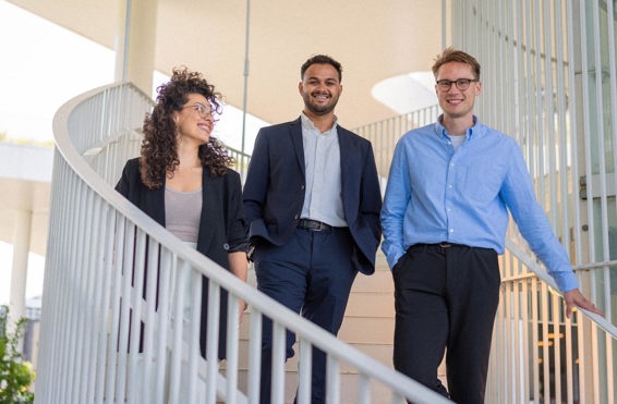 Three colleagues walking on stairs together