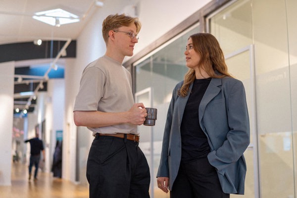 Lærke and Jeppe from Context& talking in the office