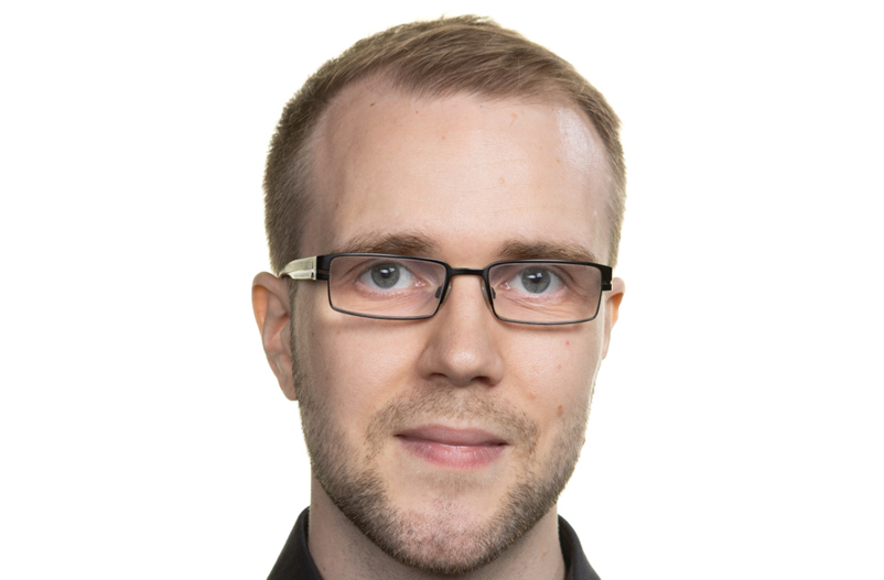 White man with glasses and black shirt